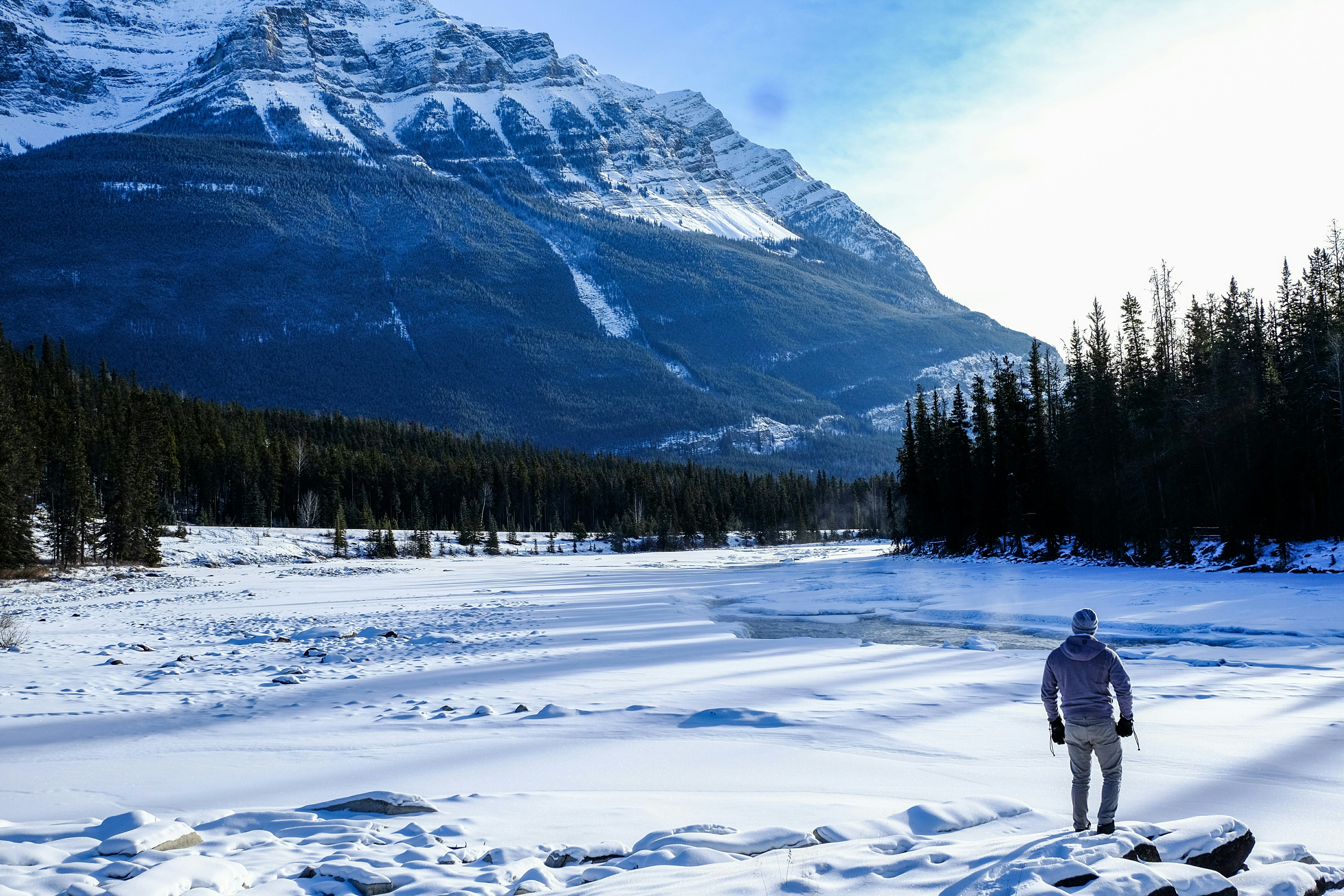 person standing on snow near mountain during daytime